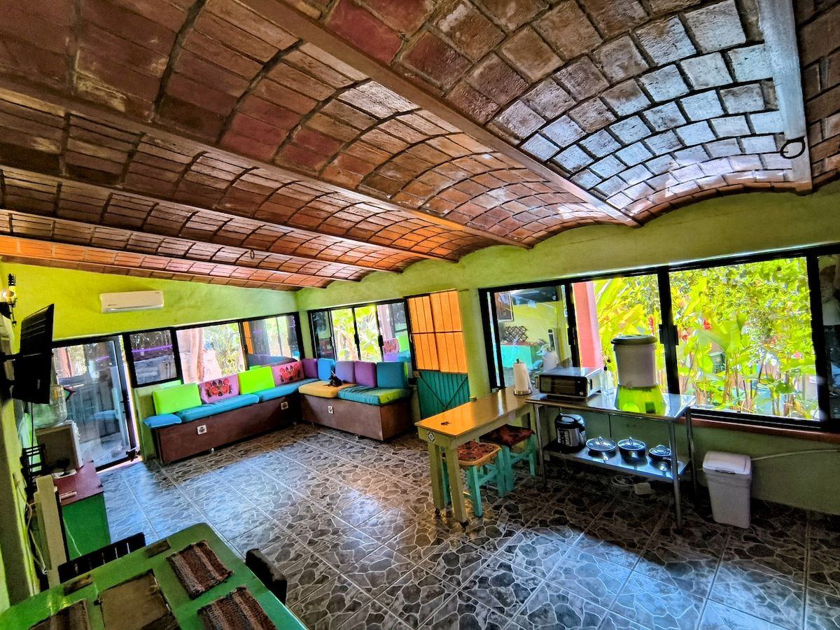 Another long room at La Casa Grande, brick vault ceiling and the garden through the windows