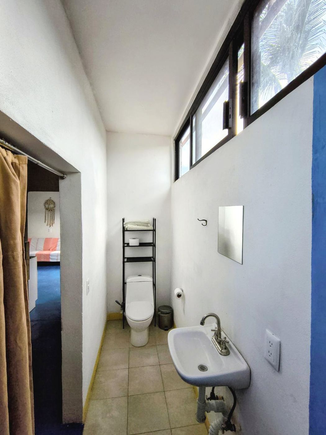 The bath at Casita Sol, a white sink under a high window